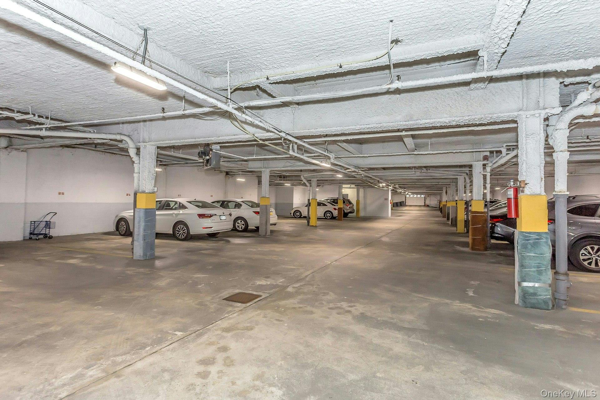 75 Noble Street, Unit 121 Lynbrook, NY 11563 - Photo 22 of 24 a view of parking garage with cars