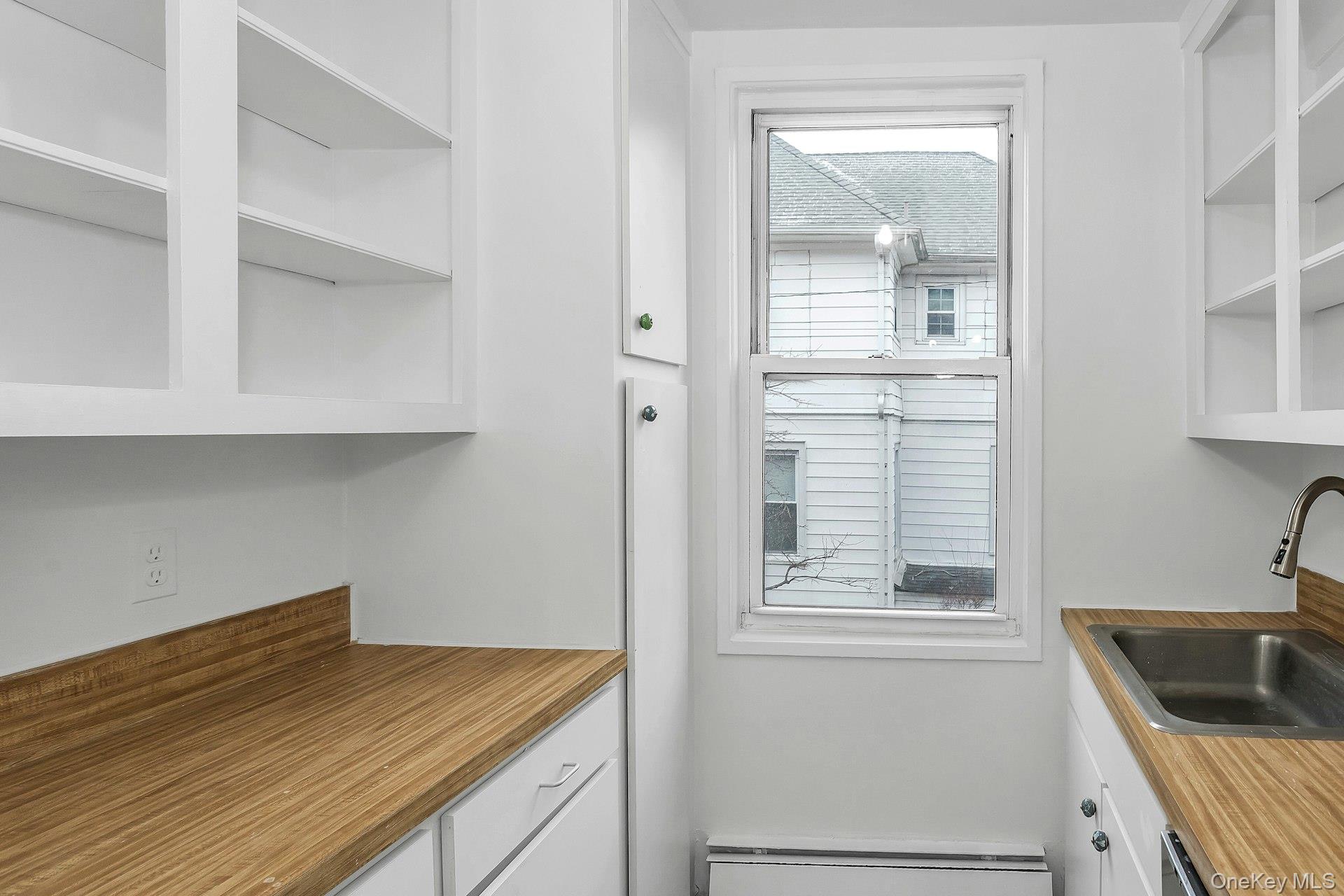 75 Noble Street, Unit 121 Lynbrook, NY 11563 - Photo 10 of 24 a kitchen with a sink and cabinets