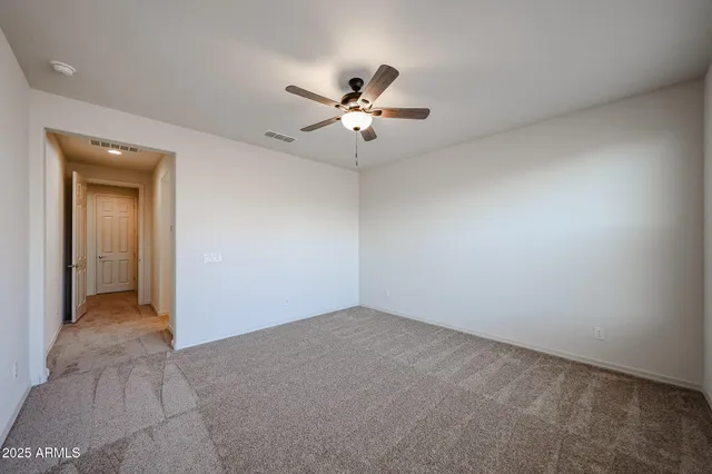 an empty room with fan and a ceiling fan