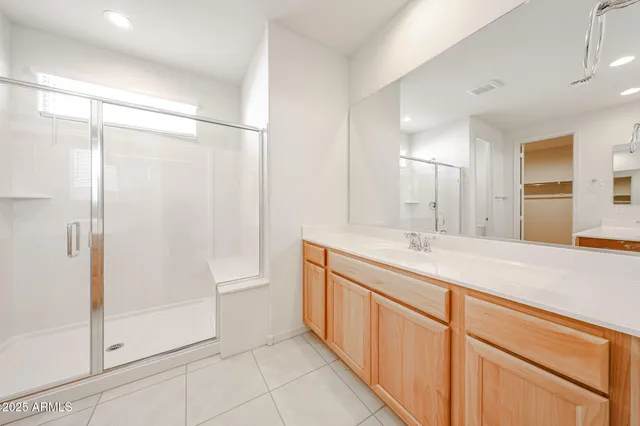 a bathroom with a double vanity sink and mirror