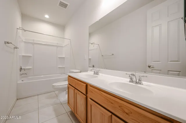 a bathroom with a granite countertop sink a toilet a bathtub and shower
