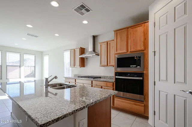 a kitchen with granite countertop a stove and a sink