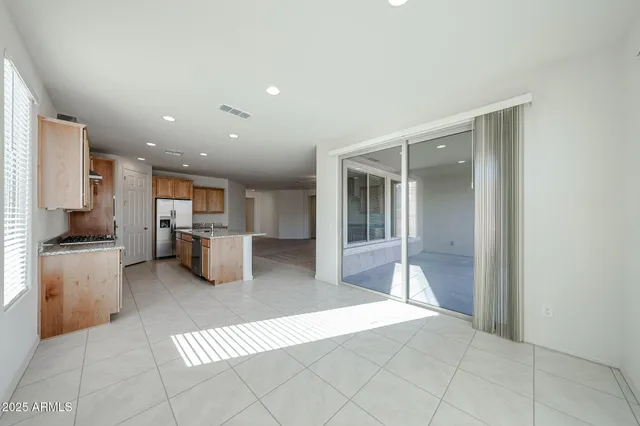 a open kitchen with white cabinets and stainless steel appliances