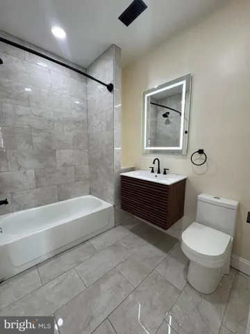 a bathroom with a sink a toilet and a bathtub