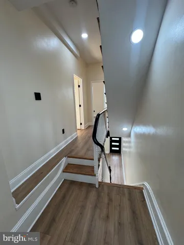 a view of entryway and hall with wooden floor