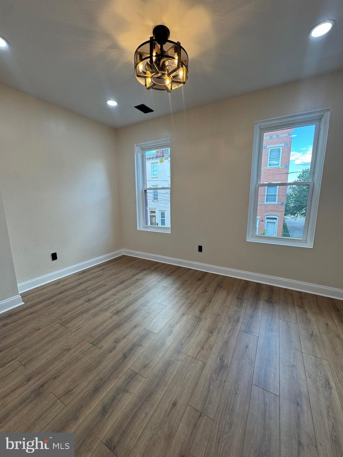 856 Perkiomen Street Philadelphia, PA 19130 - Photo 10 of 29 an empty room with wooden floor chandelier and windows