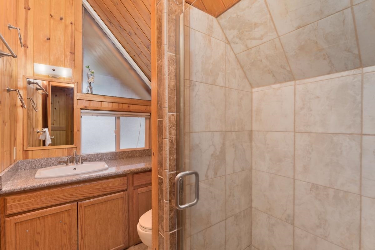 11000 Minaret Road, Unit 2 Mammoth Lakes, CA 93546 - Photo 26 of 31 a bathroom with a granite countertop sink a toilet and shower