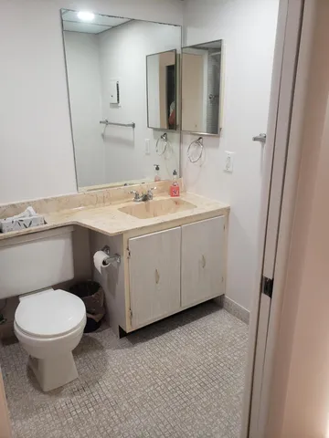 a white toilet sitting next to a shower curtain