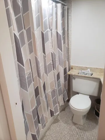 a white bath tub sitting next to a white toilet and sink