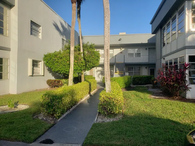 a view of a back yard of the house and front view of a house