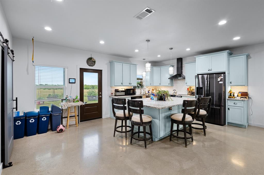 124 County Road 4511 Decatur, TX 76234 - Photo 6 of 39 a kitchen with lots of counter top space and stainless steel appliances