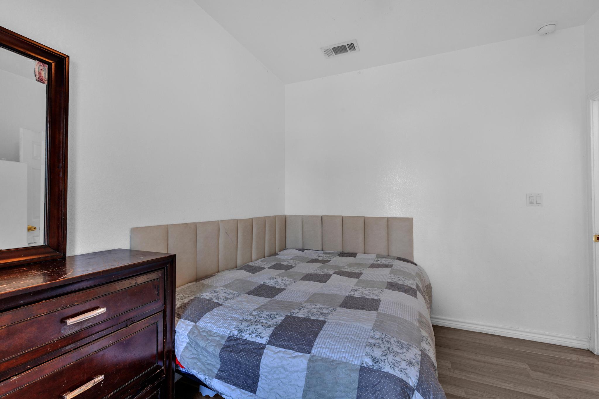 114 Crepe Myrtle Parkway Elgin, TX 78621 - Photo 28 of 40 Unit B - Bedroom with wood finished floors and baseboards