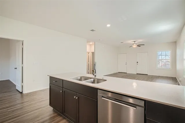 a view of a kitchen with a sink and a refrigerator