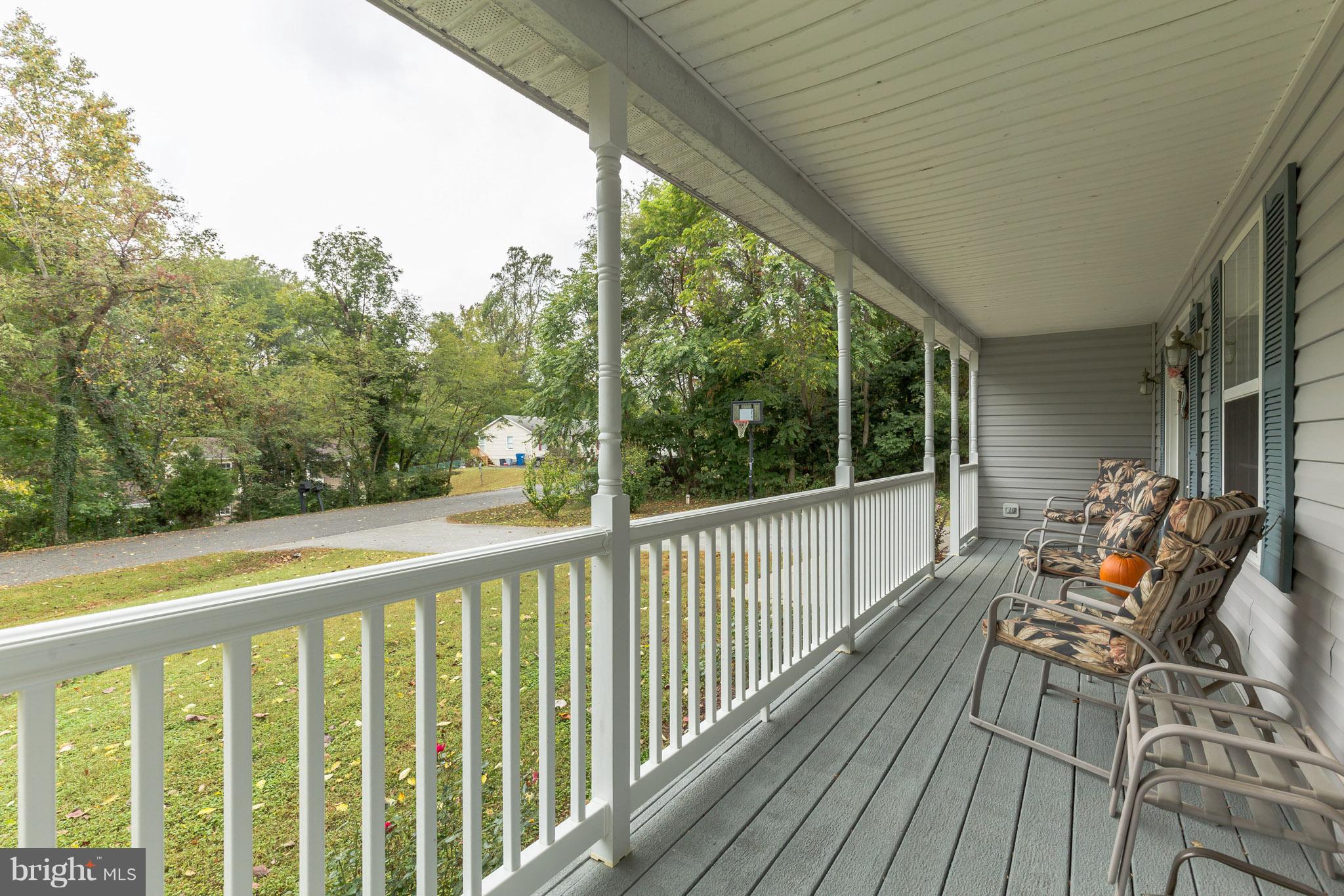 8318 Manor View Road Lusby, MD 20657 - Photo 22 of 22 a view of balcony with wooden floor and outdoor seating