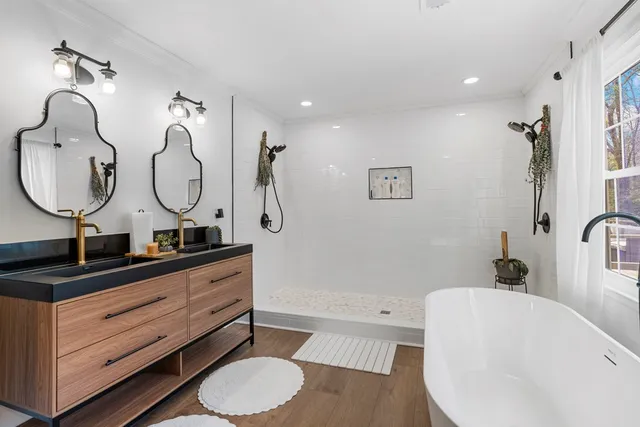 a bathroom with a double vanity sink and a mirror