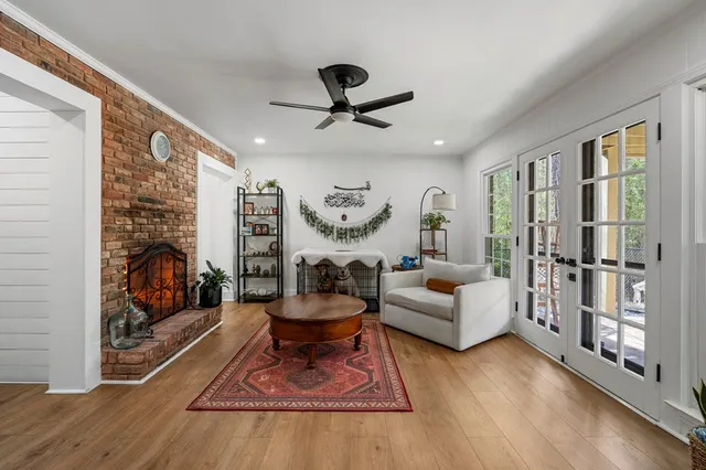 a living room with furniture a rug and a large window