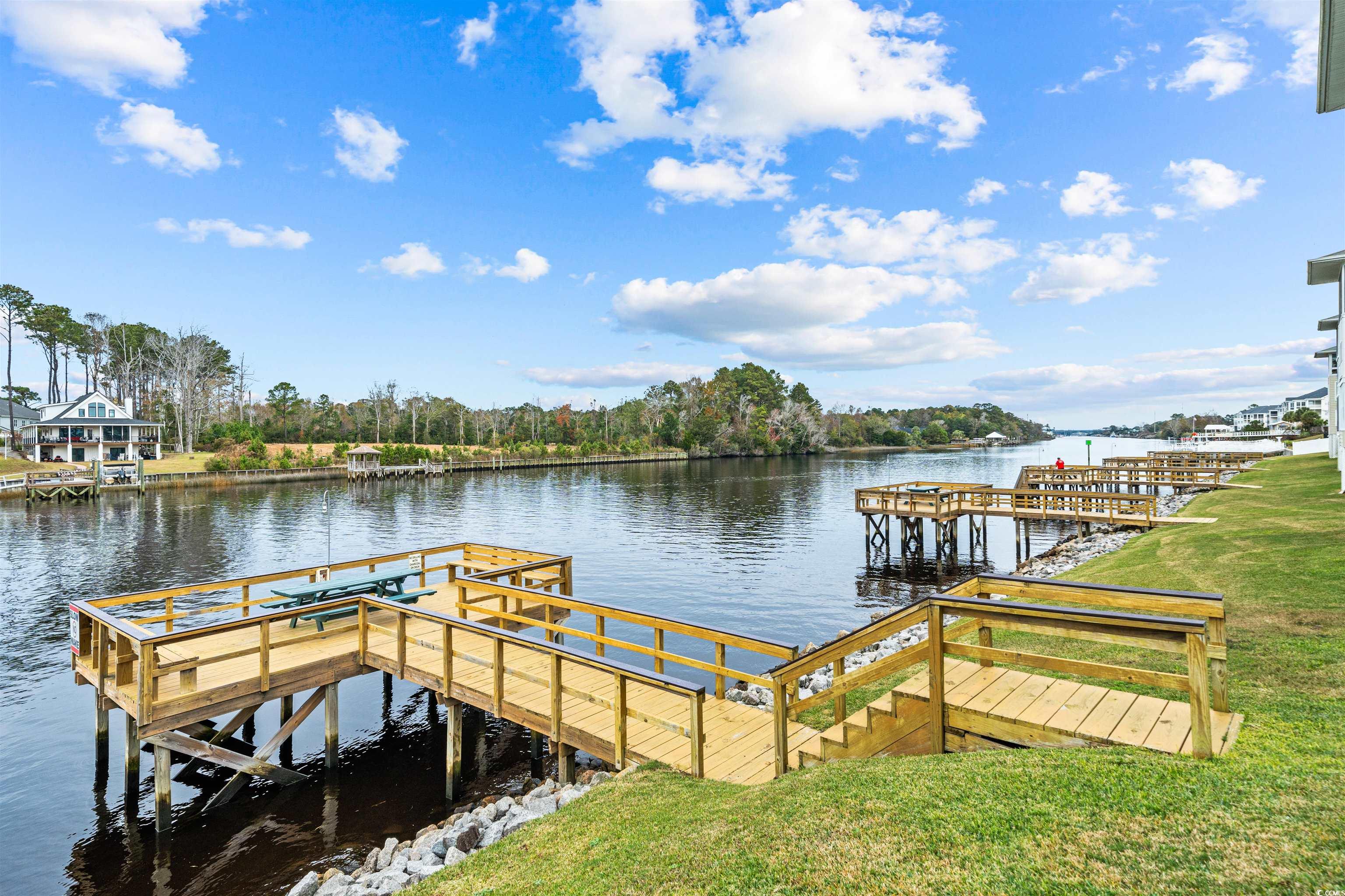 207 Landing Road, Unit F North Myrtle Beach, SC 29582 - Photo 13 of 27 View of dock featuring a water view and a lawn