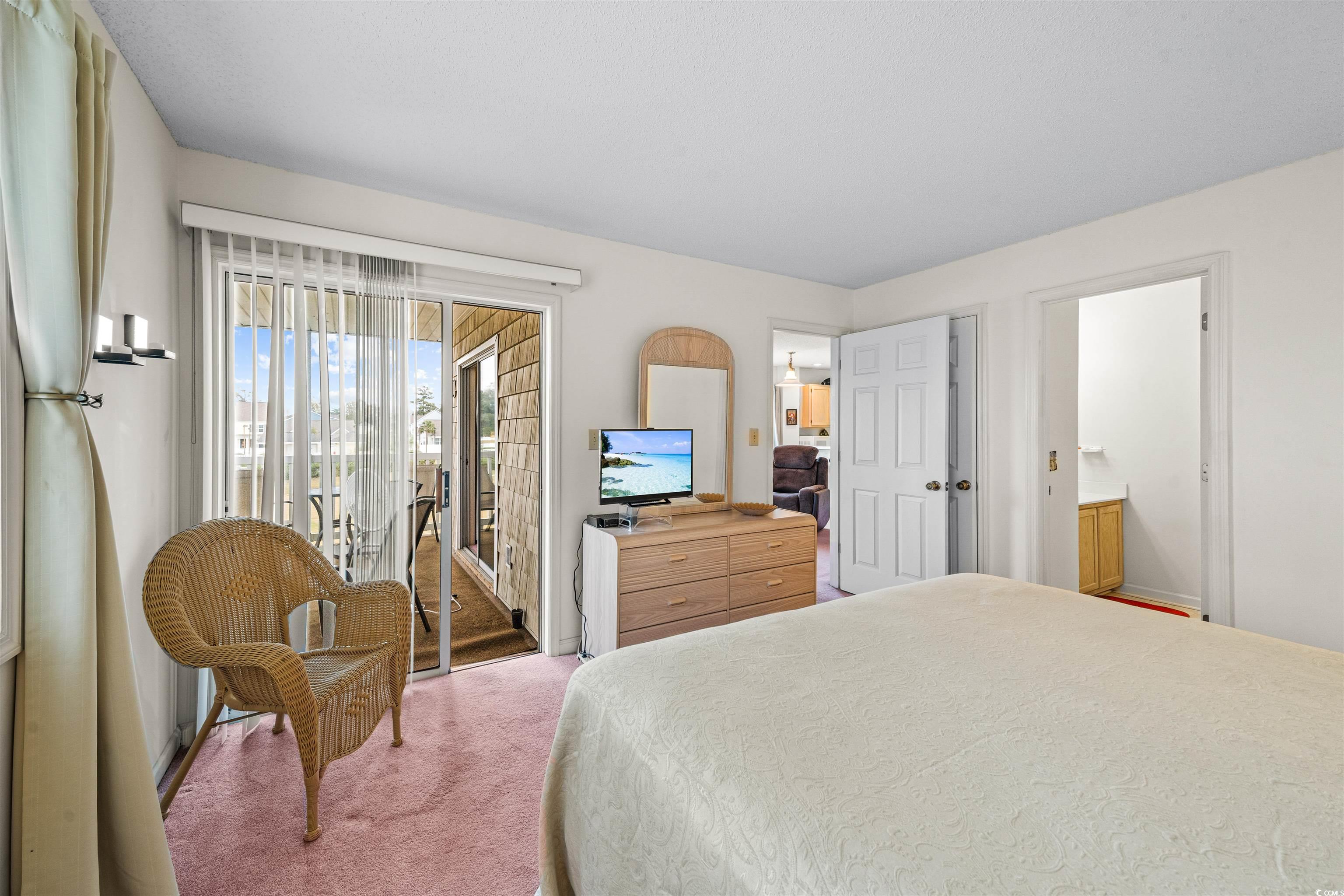 207 Landing Road, Unit F North Myrtle Beach, SC 29582 - Photo 15 of 27 Bedroom with access to exterior, carpet floors, an