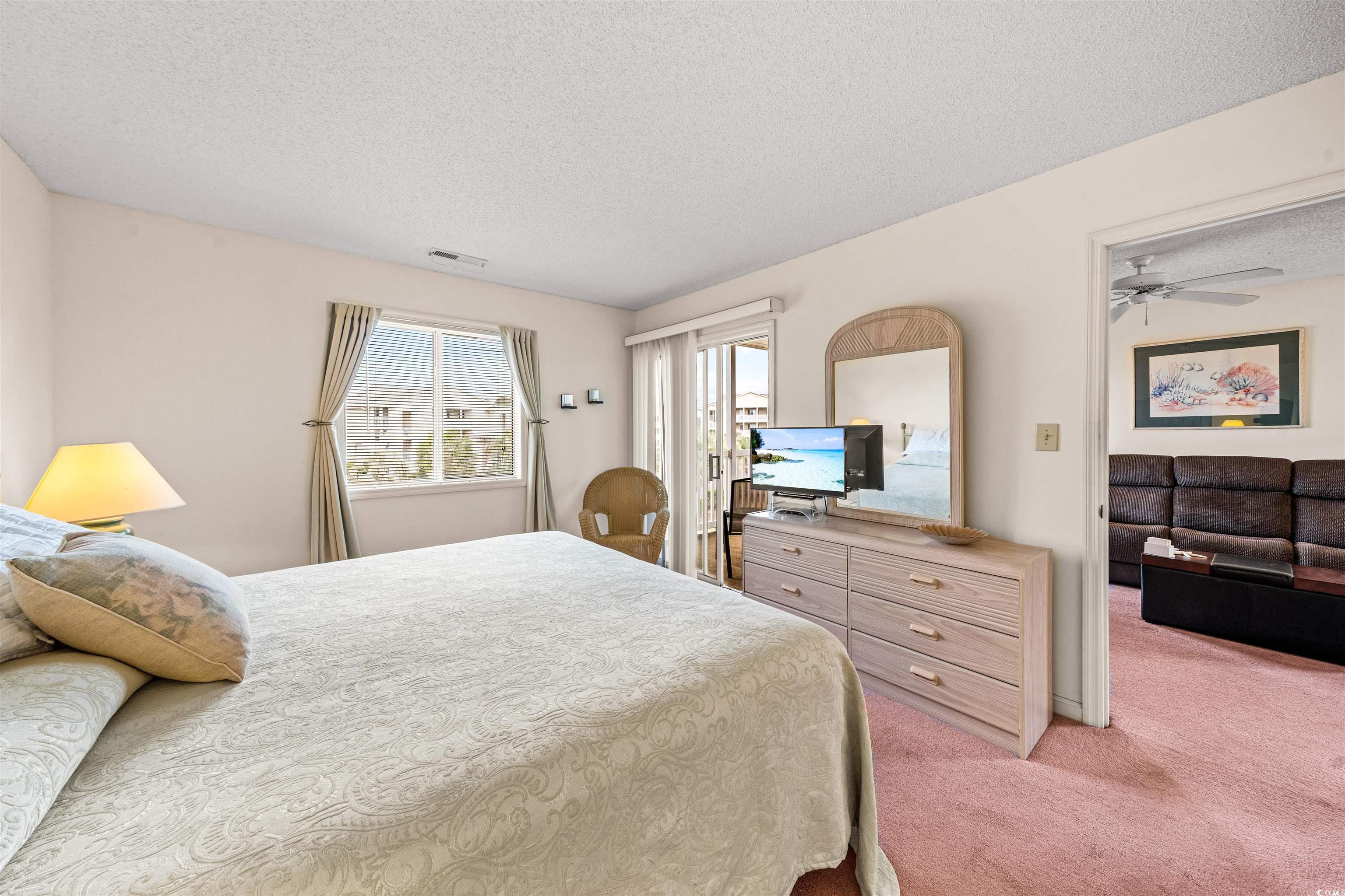 207 Landing Road, Unit F North Myrtle Beach, SC 29582 - Photo 16 of 27 Bedroom featuring carpet flooring, a textured ceil