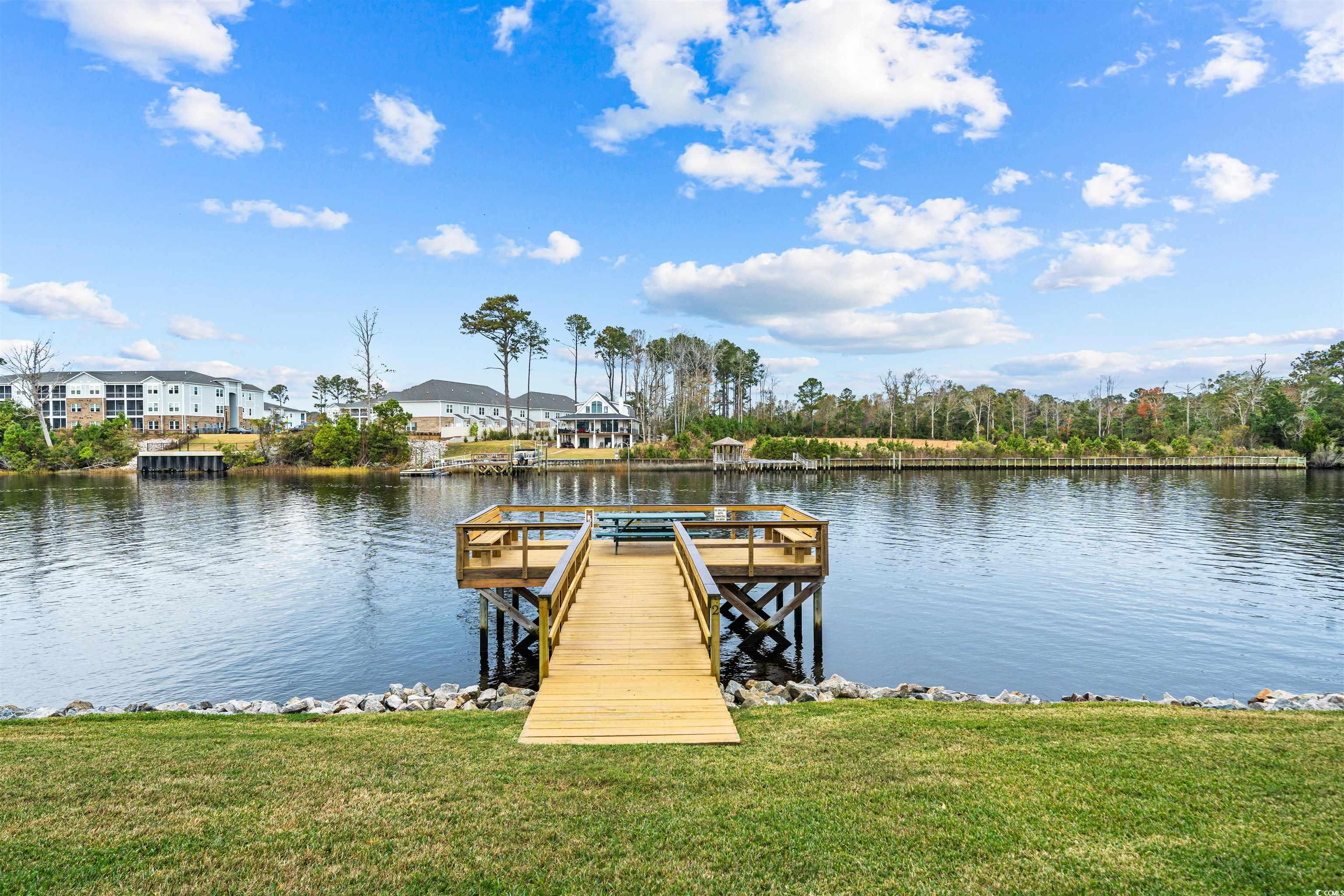 207 Landing Road, Unit F North Myrtle Beach, SC 29582 - Photo 24 of 27 View of dock featuring a lawn and a water view