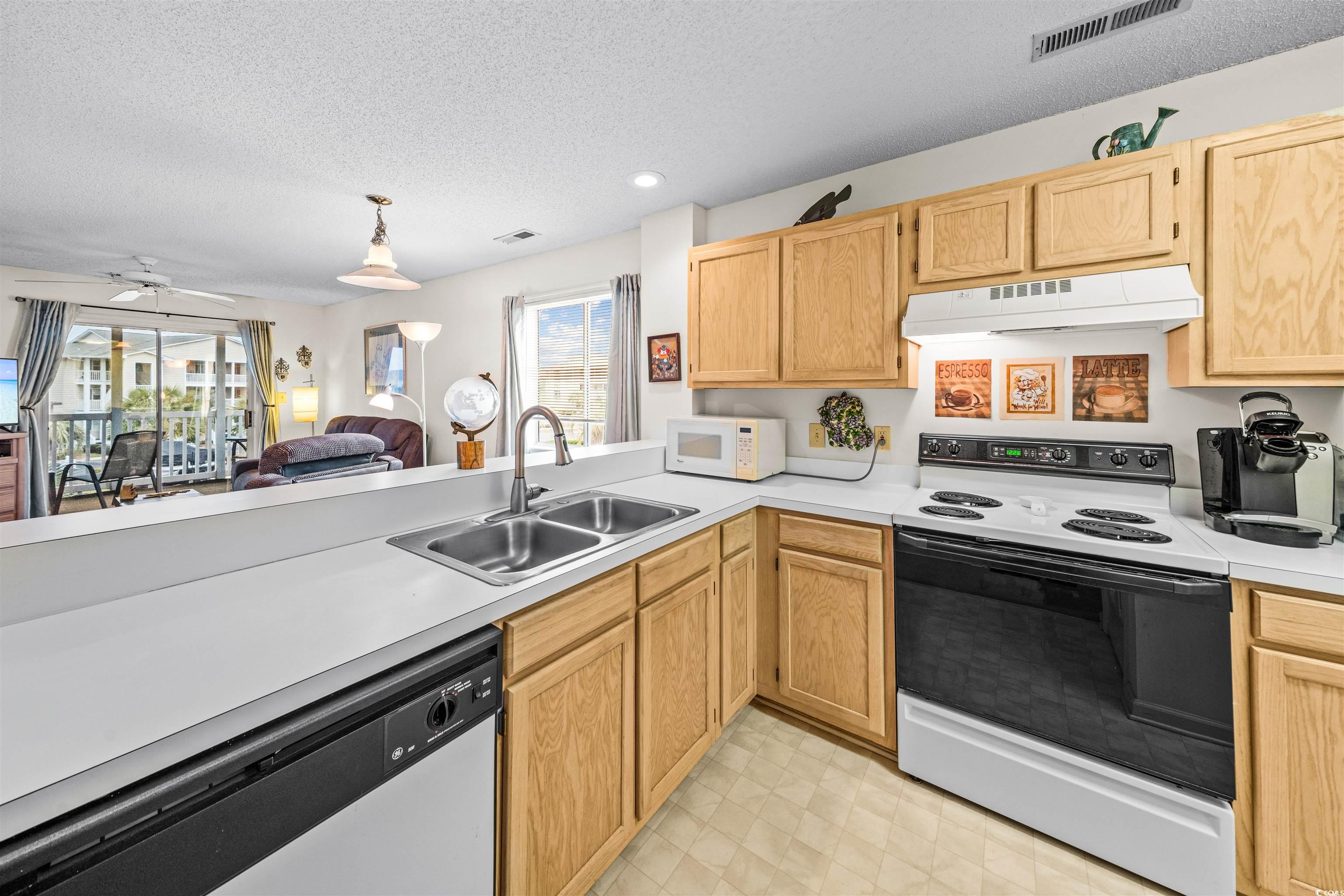 207 Landing Road, Unit F North Myrtle Beach, SC 29582 - Photo 4 of 27 Kitchen featuring a wealth of natural light, stain