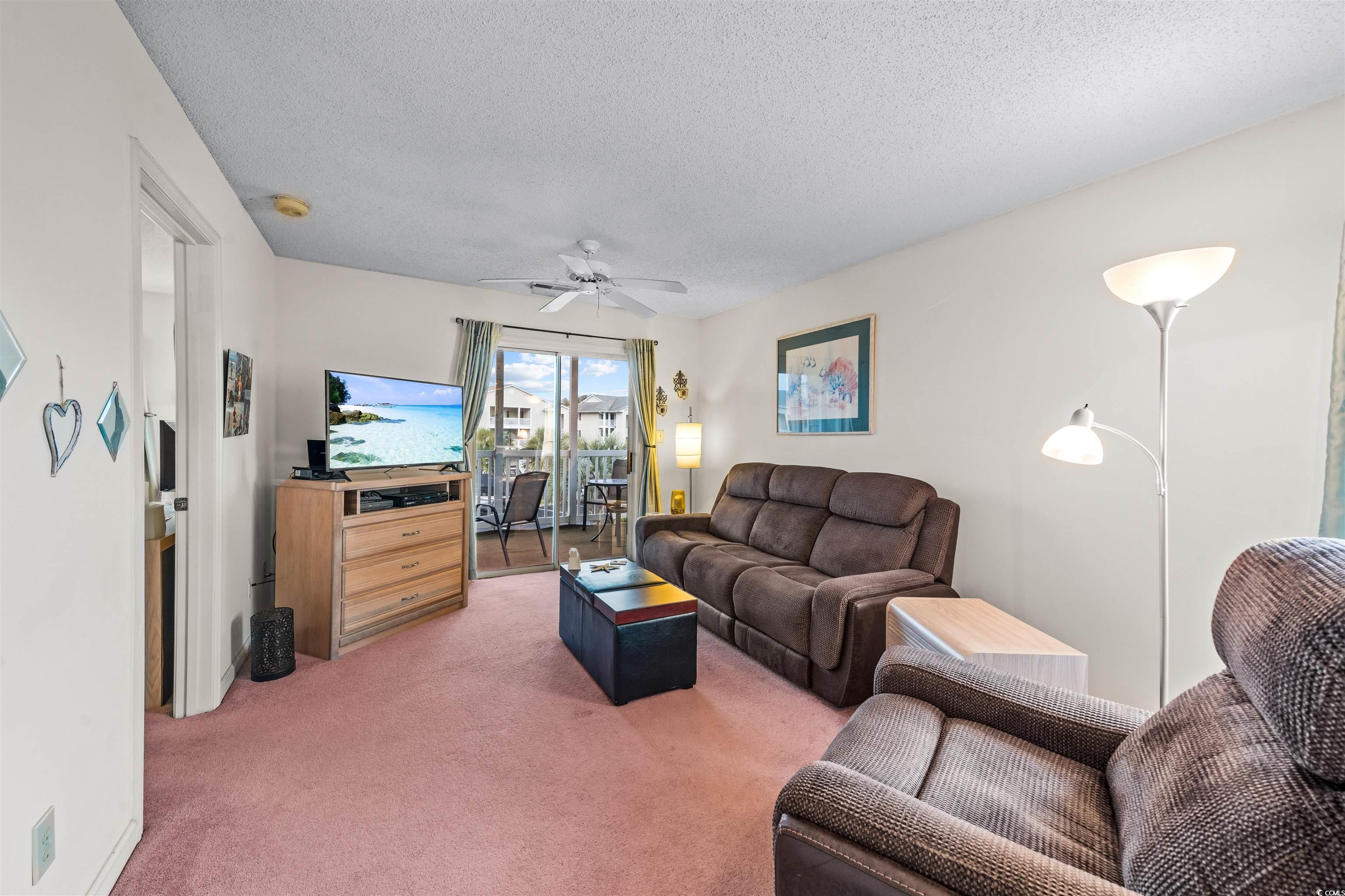 207 Landing Road, Unit F North Myrtle Beach, SC 29582 - Photo 7 of 27 Living room featuring carpet, a textured ceiling,