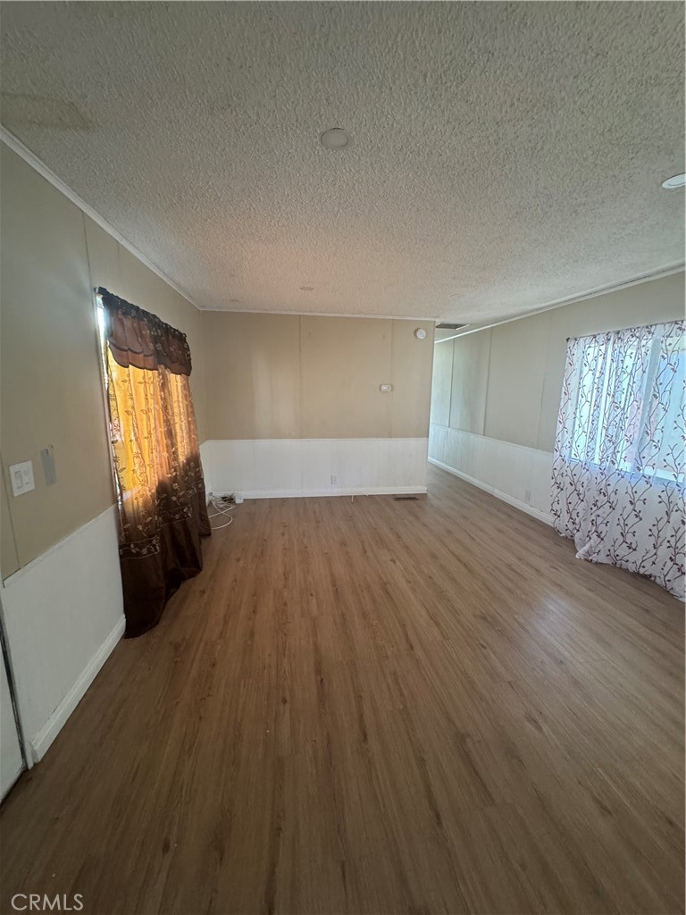 2751 Reche Canyon Road, Unit 4 Moreno Valley, CA 92555 - Photo 3 of 12 an empty room with wooden floor and windows