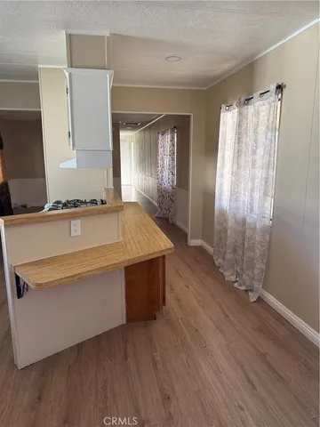a view of a kitchen with wooden floor and a sink
