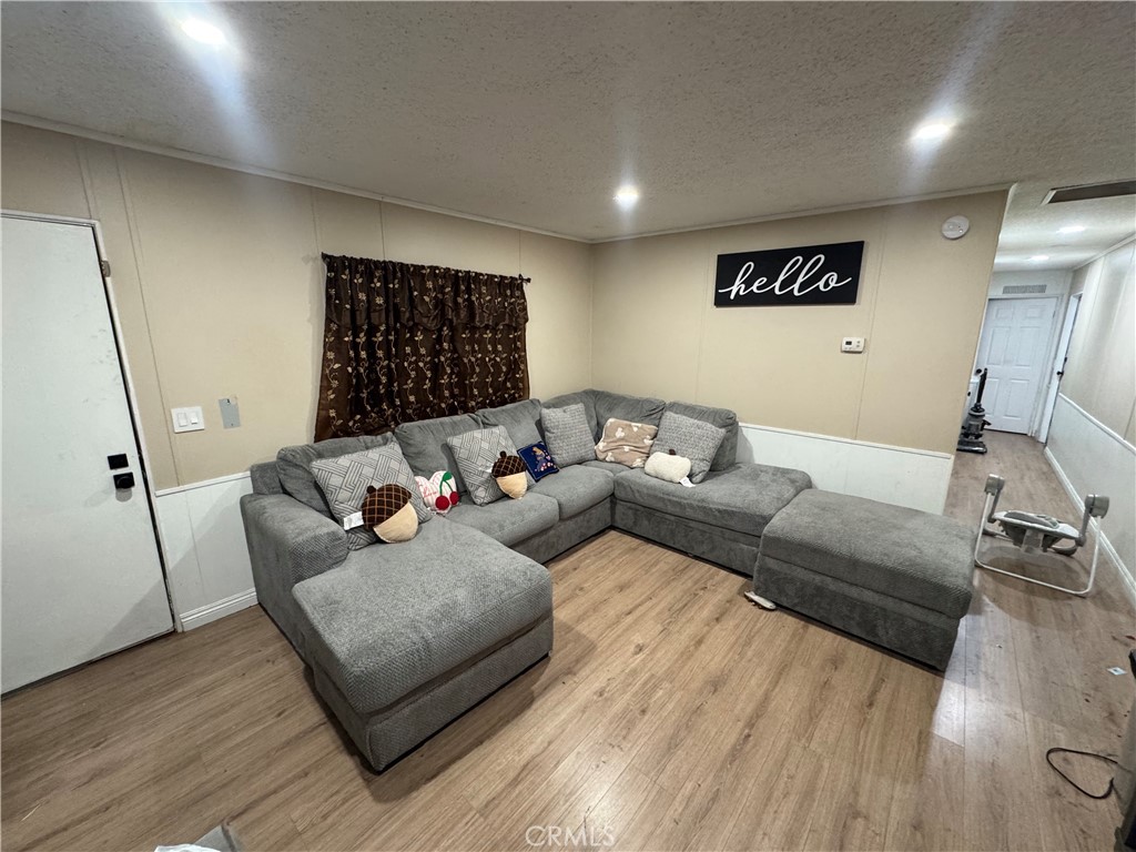 2751 Reche Canyon Road, Unit 4 Moreno Valley, CA 92555 - Photo 4 of 9 a living room with furniture and a flat screen tv