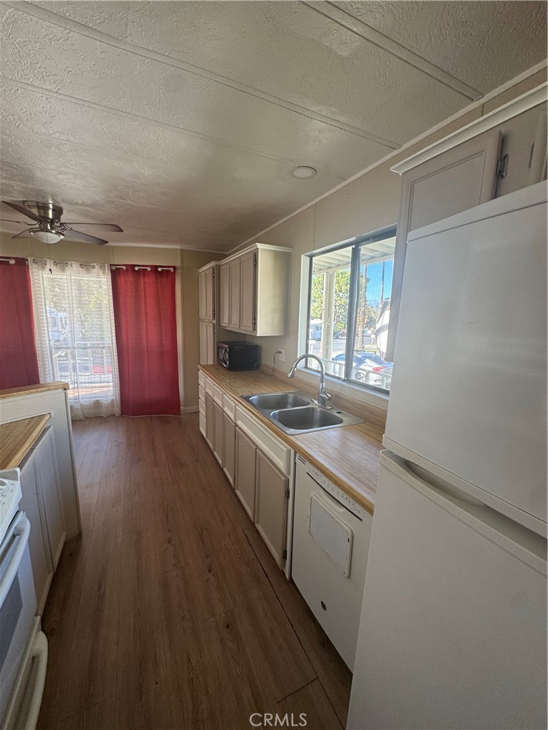 2751 Reche Canyon Road, Unit 4 Moreno Valley, CA 92555 - Photo 6 of 12 a kitchen with granite countertop a sink stove and cabinets