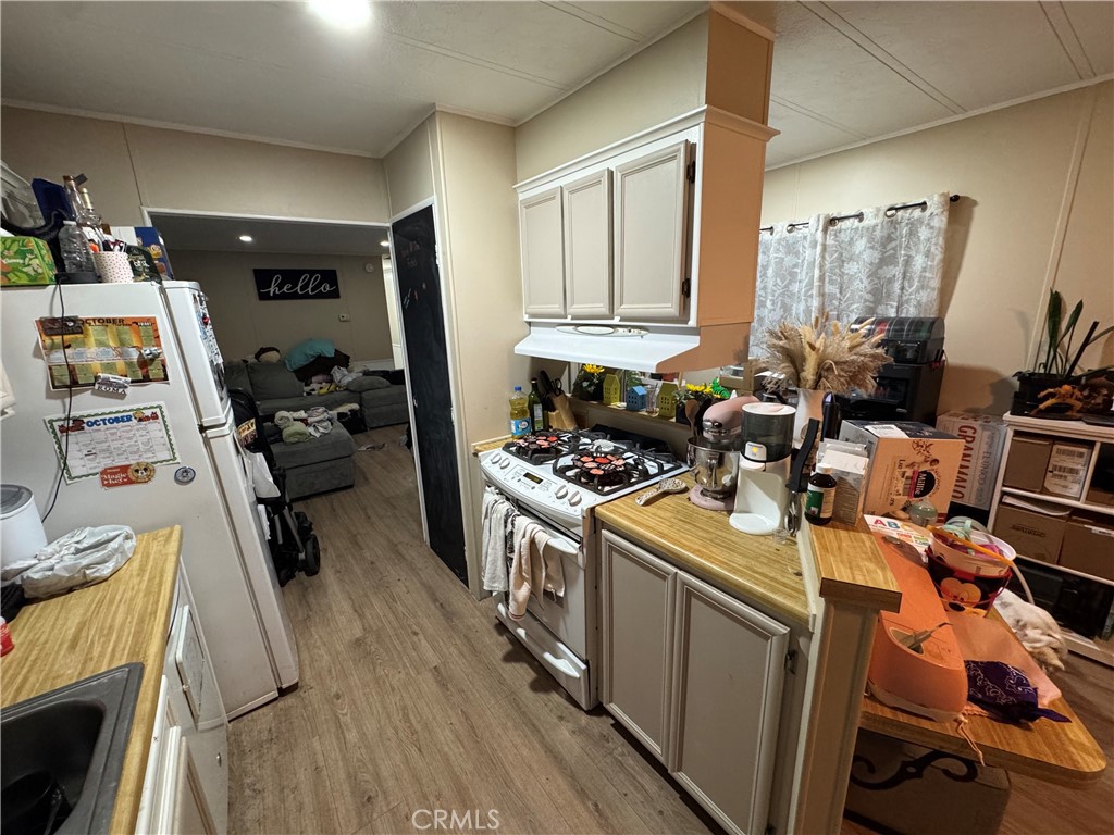 2751 Reche Canyon Road, Unit 4 Moreno Valley, CA 92555 - Photo 9 of 9 a view of a kitchen with fridge and workspace