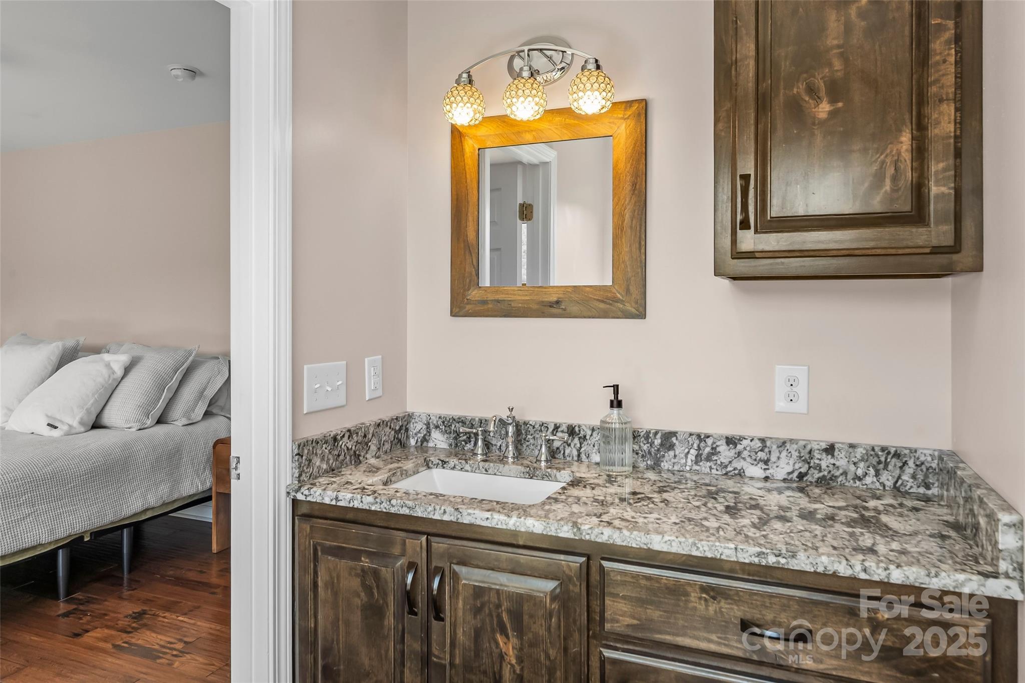 2508 Wolf Pit Road Morganton, NC 28655 - Photo 18 of 48 a bathroom with a granite countertop sink and a mirror