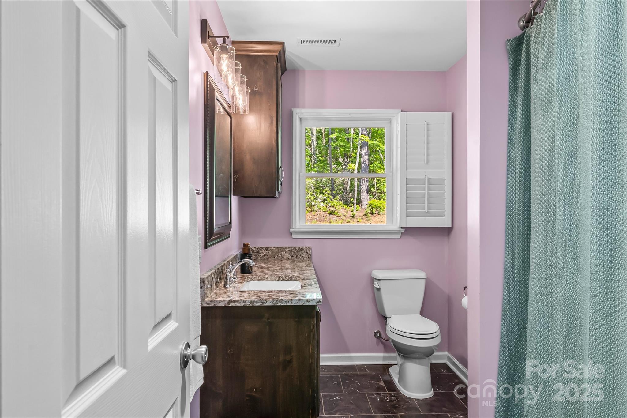 2508 Wolf Pit Road Morganton, NC 28655 - Photo 21 of 48 a bathroom with a granite countertop toilet sink and mirror