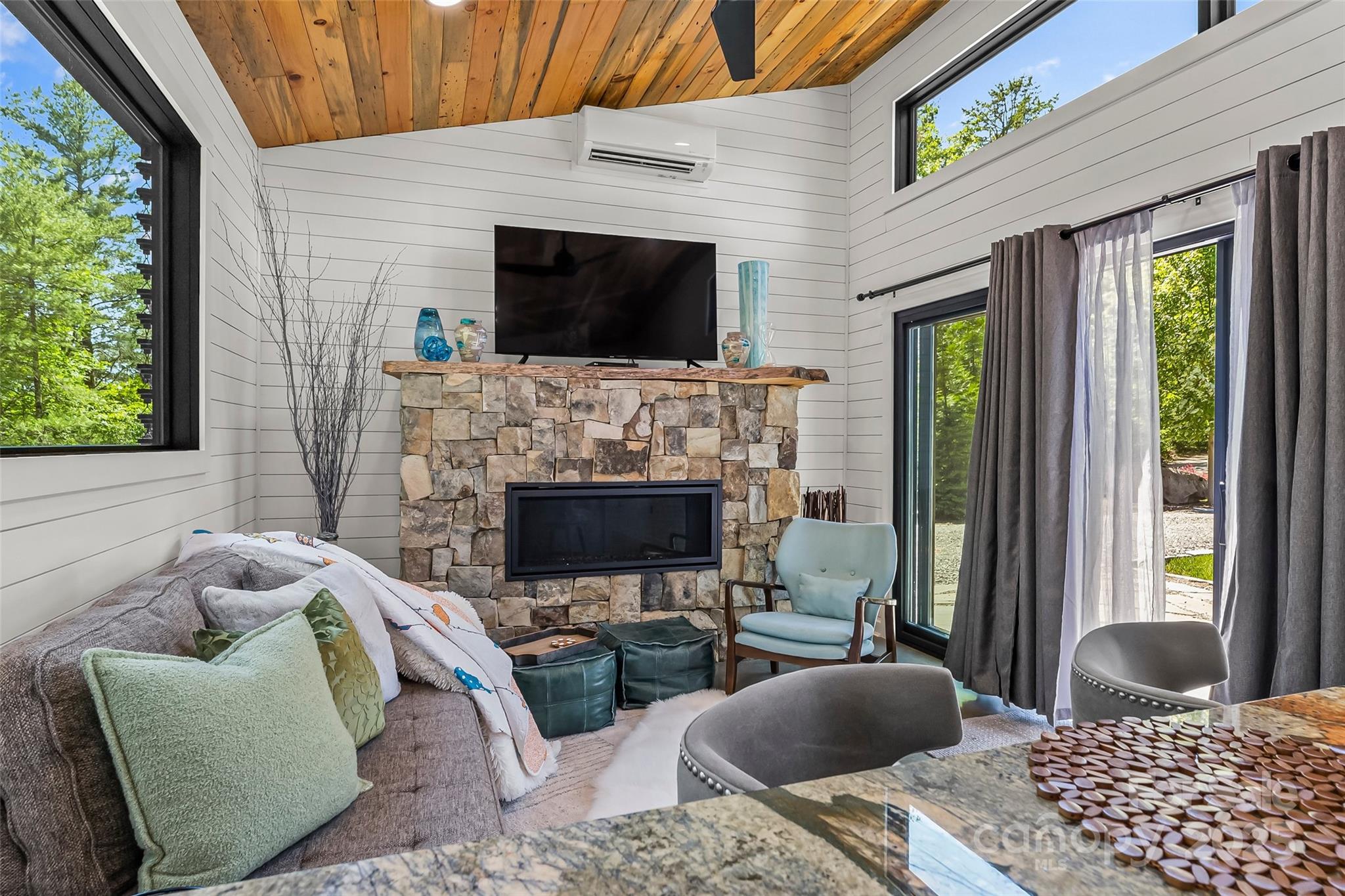 2508 Wolf Pit Road Morganton, NC 28655 - Photo 36 of 48 a living room with furniture a flat screen tv and a fireplace