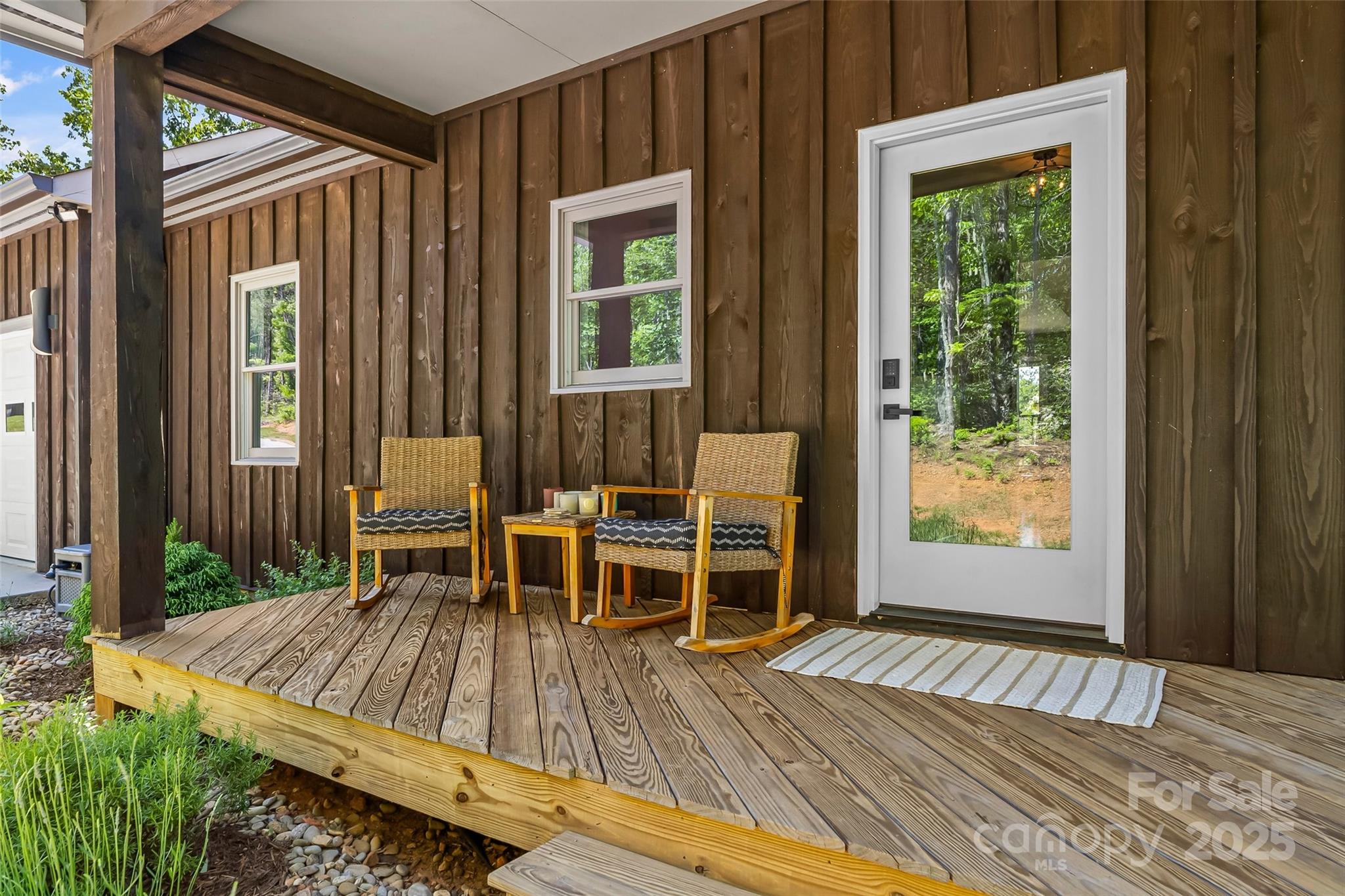 2508 Wolf Pit Road Morganton, NC 28655 - Photo 47 of 48 a view of a patio with table and chairs with wooden floor and floor to ceiling window
