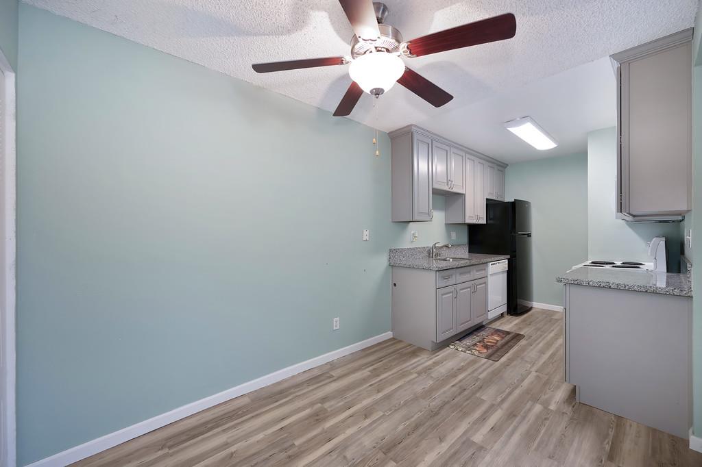 9160 Madison Avenue, Unit 68 Fair Oaks, CA 95628 - Photo 11 of 35 a kitchen with a refrigerator a stove and white cabinets