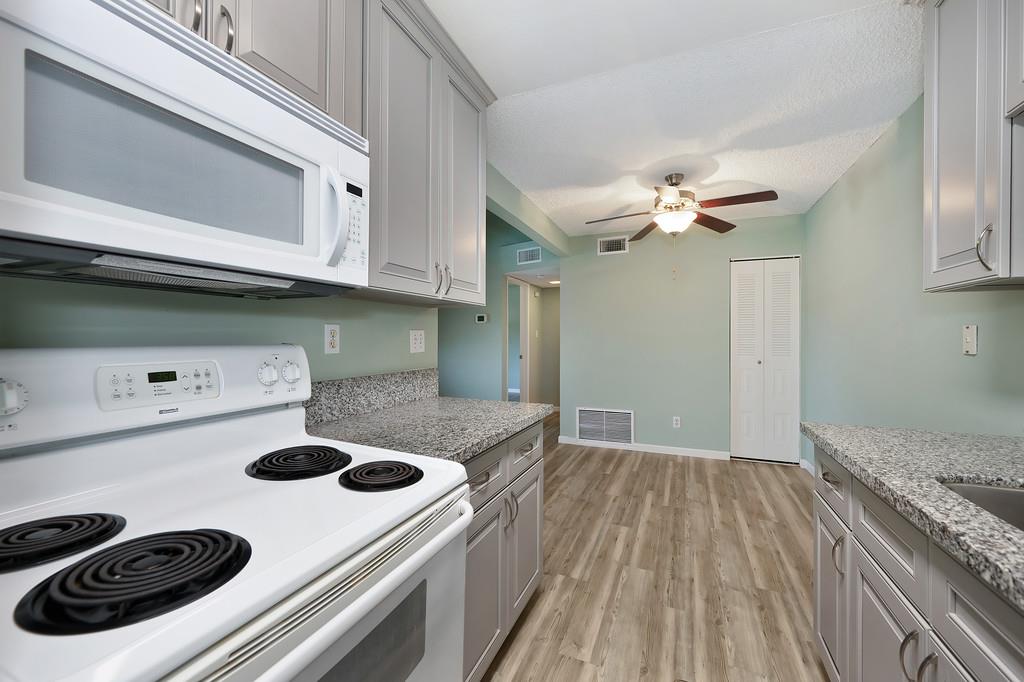 9160 Madison Avenue, Unit 68 Fair Oaks, CA 95628 - Photo 20 of 35 a kitchen with a stove and a microwave
