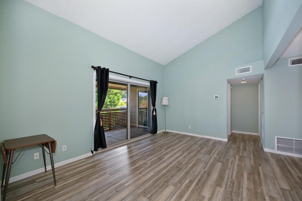 9160 Madison Avenue, Unit 68 Fair Oaks, CA 95628 - Photo 7 of 35 a view of an empty room with wooden floor and a window
