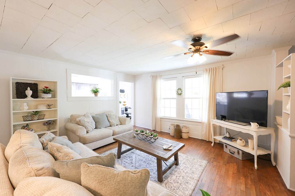 211 Williams Street Valley, AL 36854 - Photo 16 of 28 a living room with furniture a flat screen tv and wooden floor