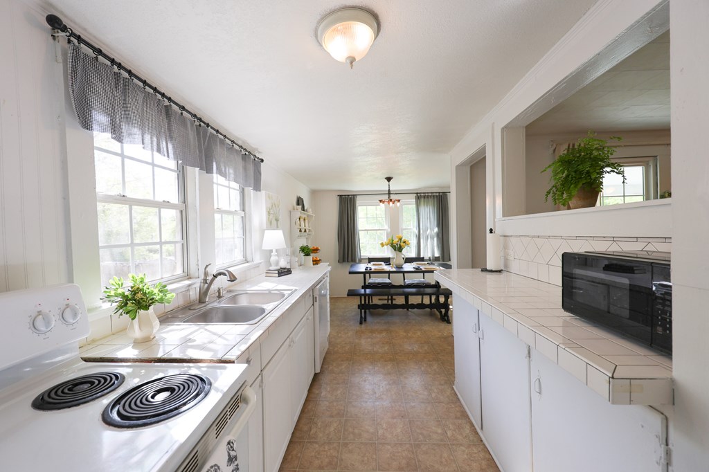 211 Williams Street Valley, AL 36854 - Photo 18 of 28 a kitchen with a stove and a white cabinets