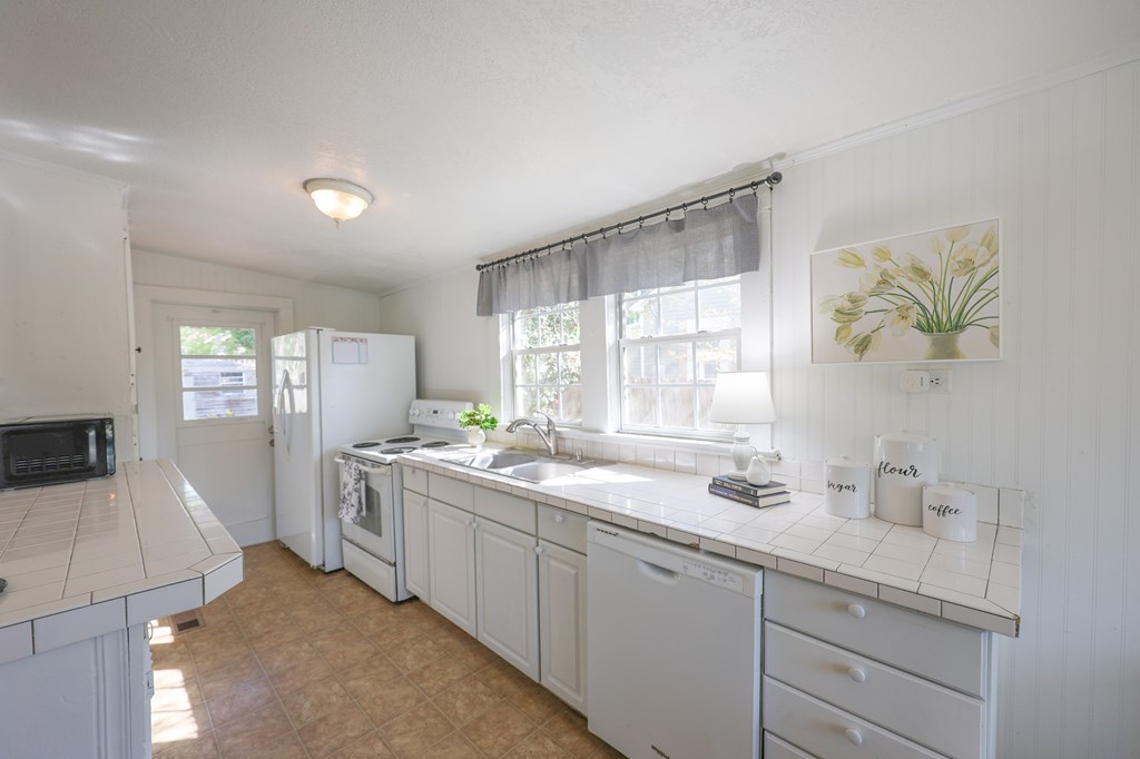 211 Williams Street Valley, AL 36854 - Photo 22 of 28 a kitchen with a sink stove and cabinets