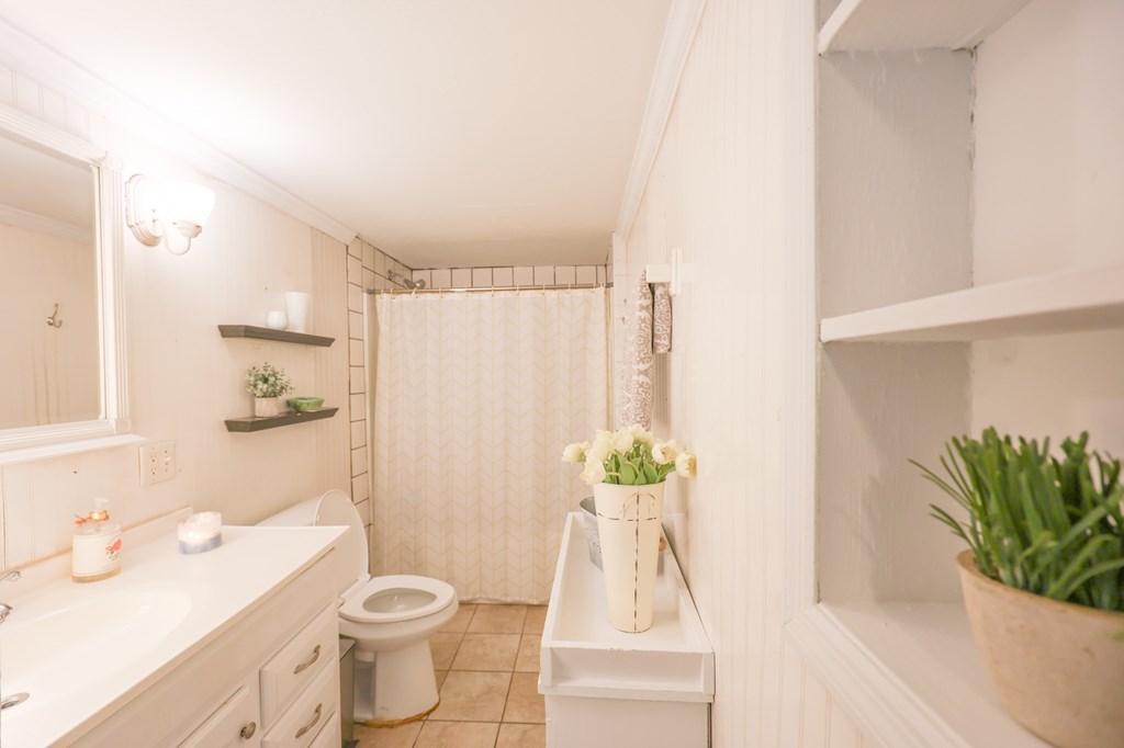 211 Williams Street Valley, AL 36854 - Photo 27 of 28 a white toilet sitting next to a bathroom sink