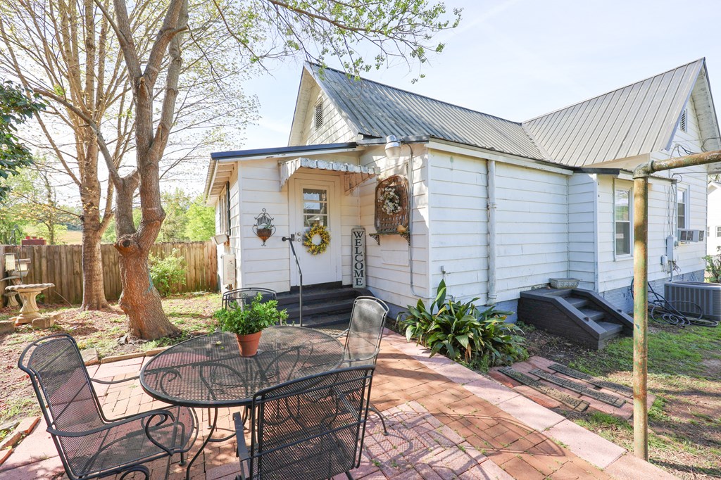 211 Williams Street Valley, AL 36854 - Photo 5 of 28 a view of a patio with table and chairs potted plants and a large tree