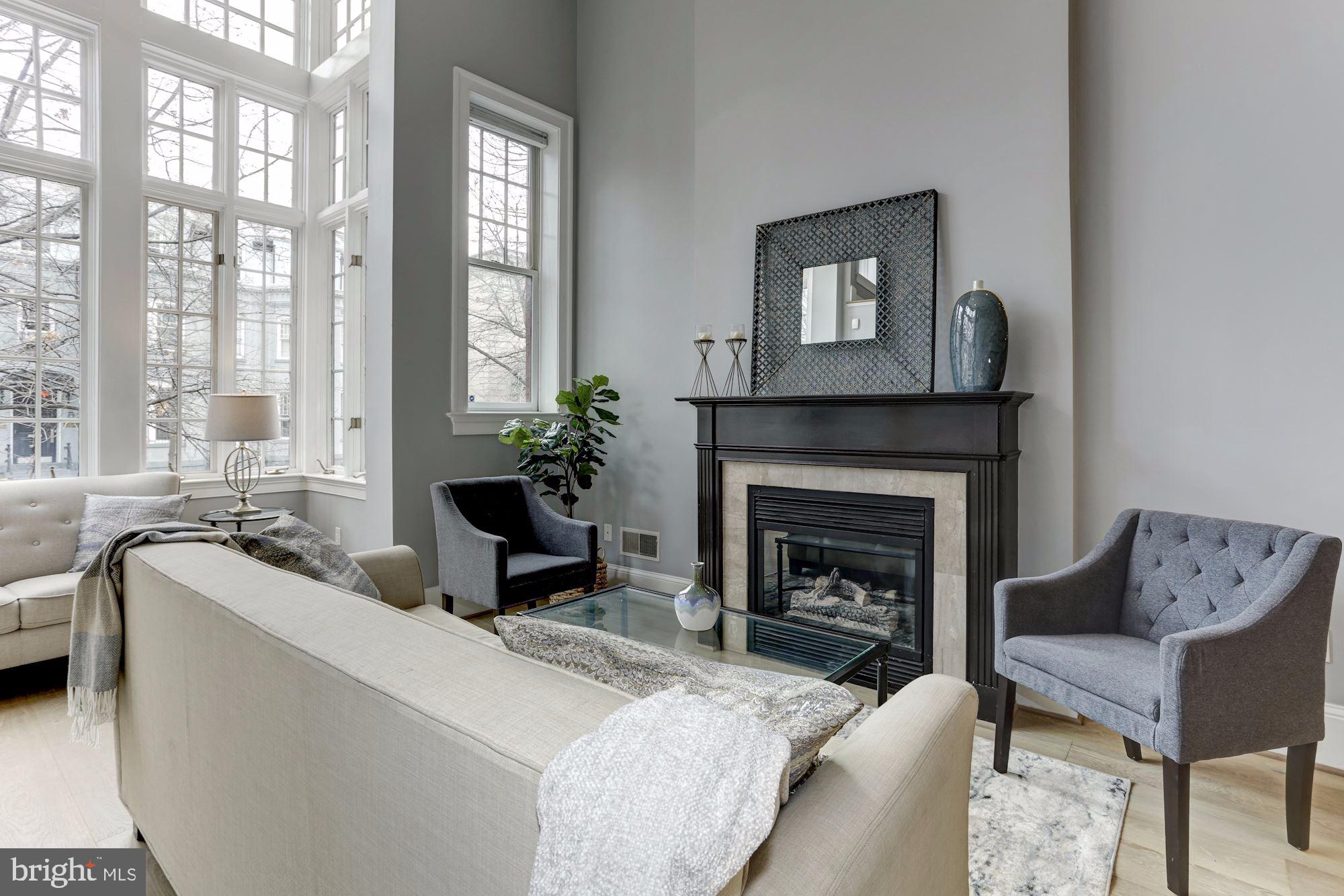 1515 P Street Northwest, Unit 2 Washington, DC 20005 - Photo 3 of 17 Sunny Living Room with Gas Fireplace + Wood Mantle