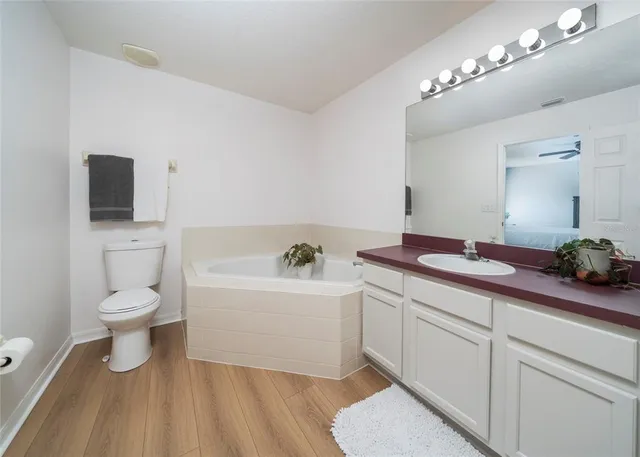 a spacious bathroom with a sink and a mirror