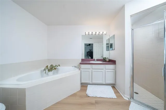 a spacious bathroom with a sink and a mirror