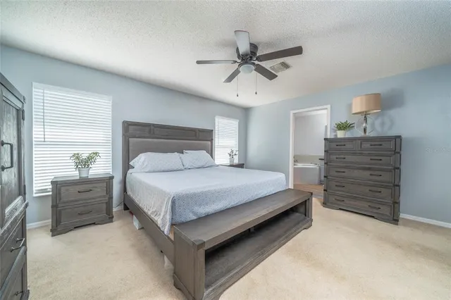 a bedroom with a bed and cabinet