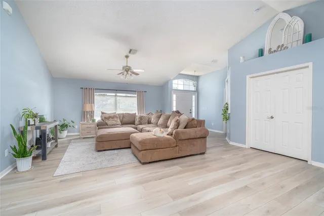 a living room with furniture and a wooden floor