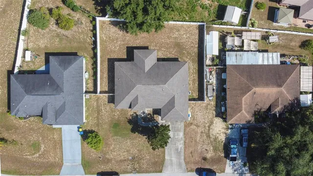 an aerial view of a house with a yard and potted plants