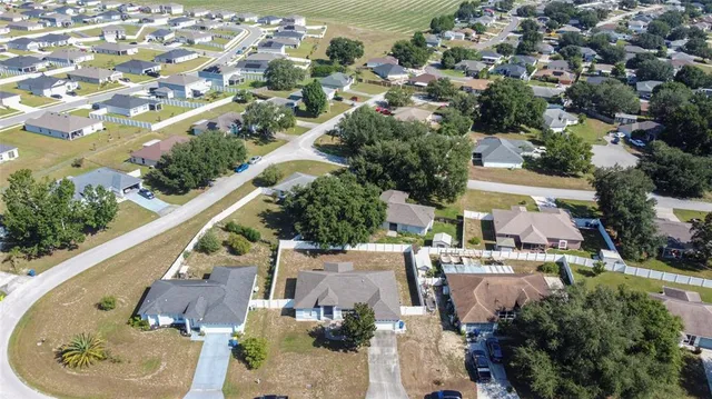 an aerial view of residential houses with outdoor space and street view